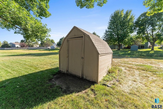 view of outbuilding featuring a lawn