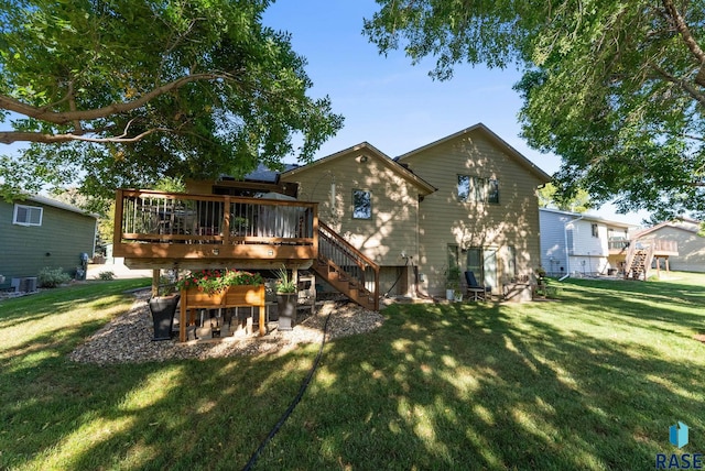 back of property featuring a yard, cooling unit, and a deck