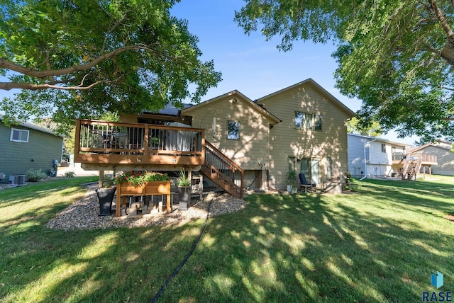 back of property with cooling unit, a wooden deck, and a lawn