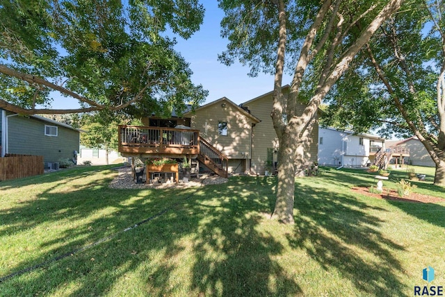 back of property with a deck and a lawn