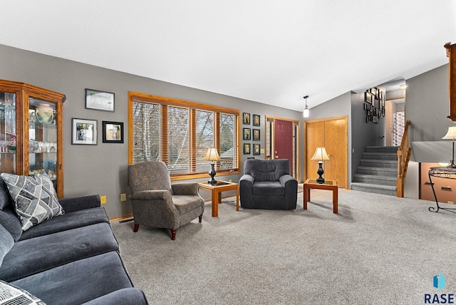 carpeted living room with lofted ceiling