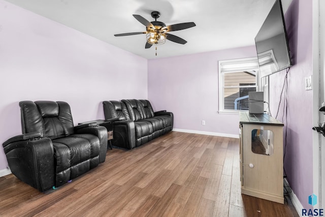 living room featuring hardwood / wood-style floors and ceiling fan