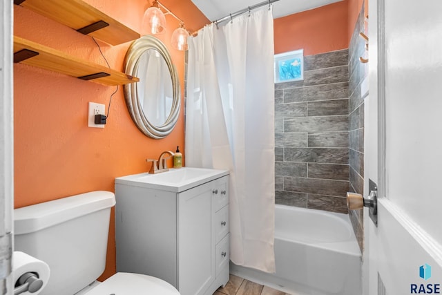 full bathroom with vanity, shower / tub combo with curtain, and toilet