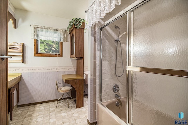 full bathroom with bath / shower combo with glass door, vanity, and toilet