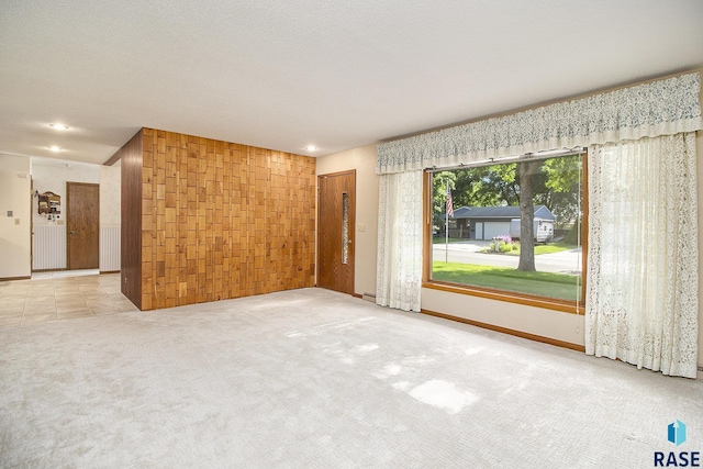 carpeted empty room featuring a textured ceiling