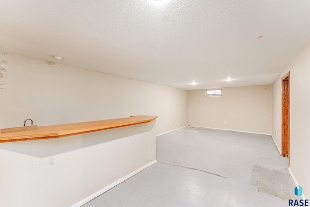 basement featuring a textured ceiling