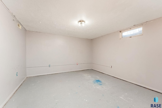 basement featuring a textured ceiling