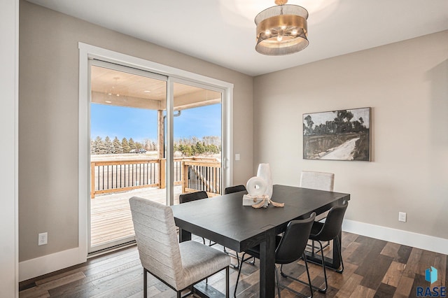 dining space with dark hardwood / wood-style flooring