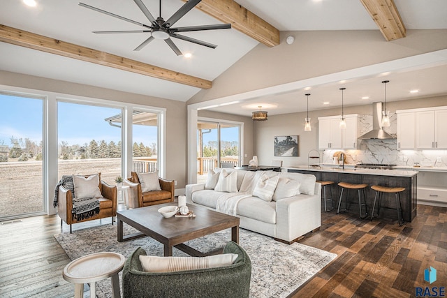 living room with lofted ceiling with beams, ceiling fan, sink, and dark hardwood / wood-style flooring