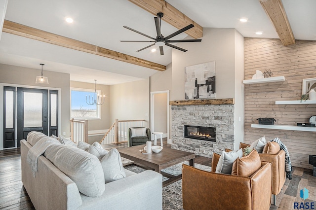 living room featuring a stone fireplace, dark wood-type flooring, and beam ceiling