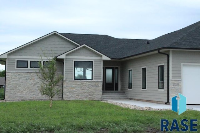 view of front facade with a front lawn and a patio