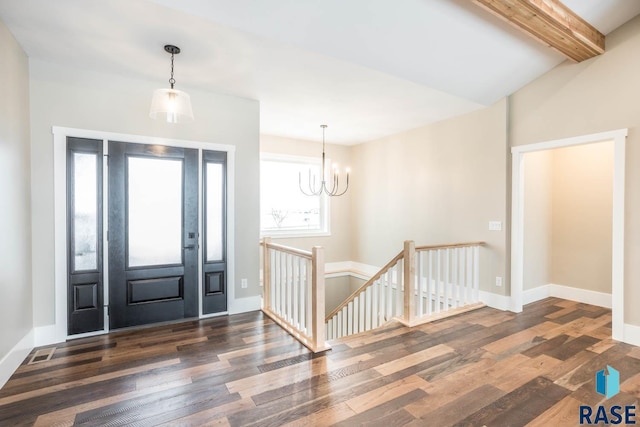 entrance foyer with an inviting chandelier, dark hardwood / wood-style floors, and beam ceiling