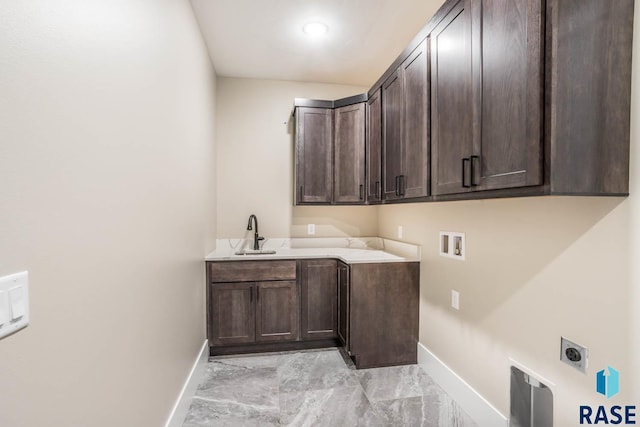 laundry room with cabinets, electric dryer hookup, sink, and washer hookup