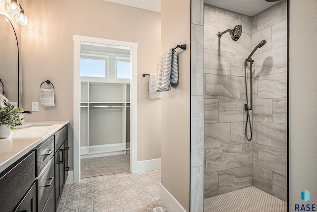 bathroom featuring vanity and tiled shower