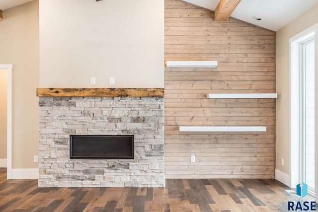 details featuring beamed ceiling, hardwood / wood-style flooring, a fireplace, and wooden walls