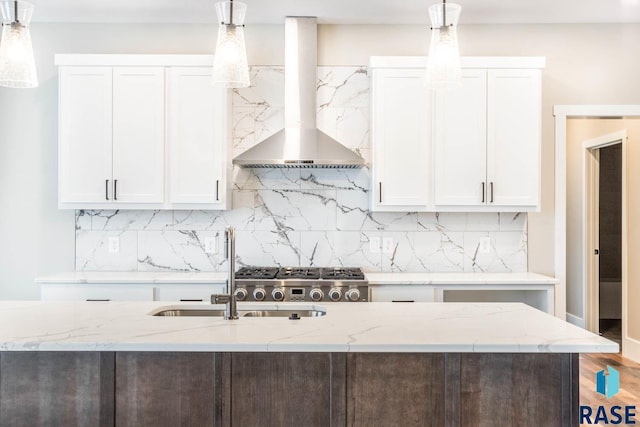 kitchen with pendant lighting, light stone countertops, extractor fan, and white cabinets