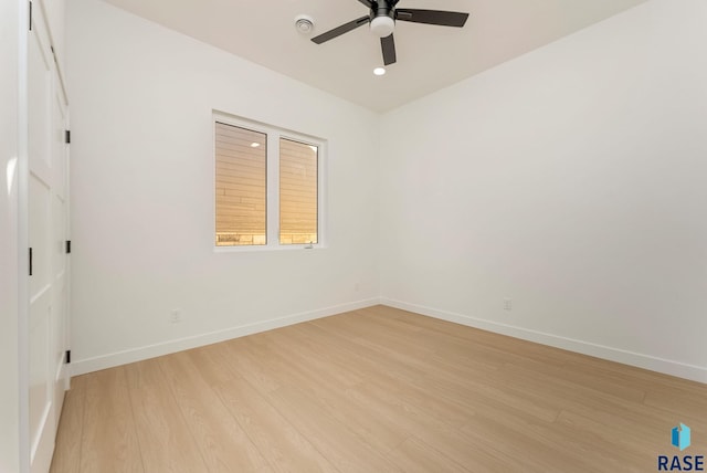 spare room featuring ceiling fan and light hardwood / wood-style flooring