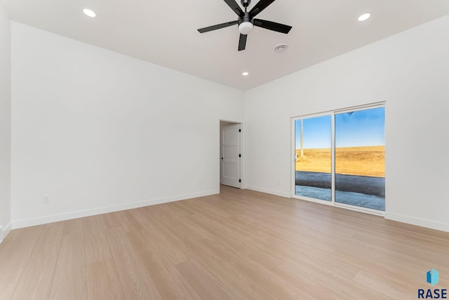 spare room with ceiling fan and light wood-type flooring