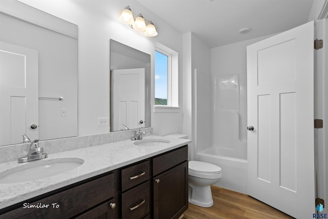 full bathroom with vanity, toilet, hardwood / wood-style floors, and shower / bathing tub combination