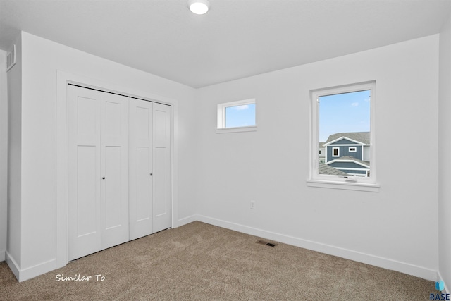 unfurnished bedroom with carpet floors and a closet