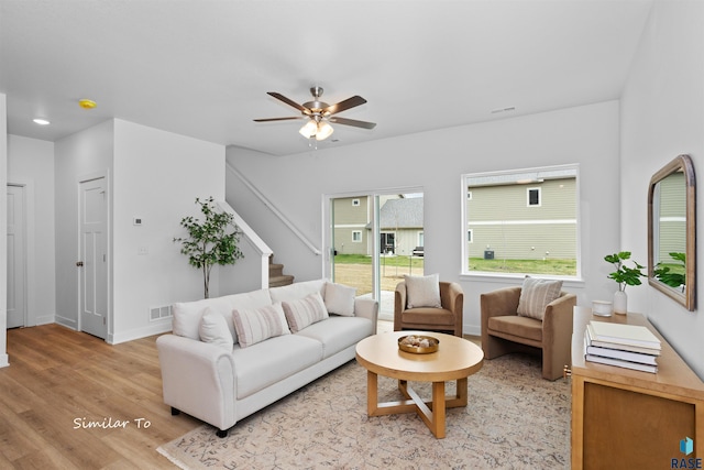 living room with ceiling fan and light wood-type flooring