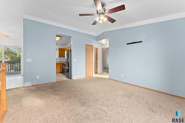 interior space with ceiling fan, lofted ceiling, and light carpet