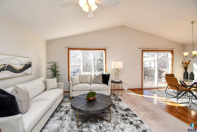 living room featuring ceiling fan with notable chandelier, lofted ceiling, and hardwood / wood-style floors