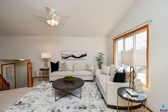 carpeted living room featuring ceiling fan and vaulted ceiling