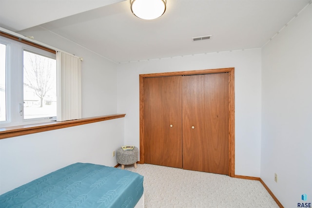 carpeted bedroom with a closet