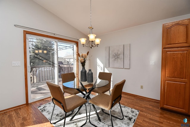 dining space with dark wood-type flooring, vaulted ceiling, and a chandelier