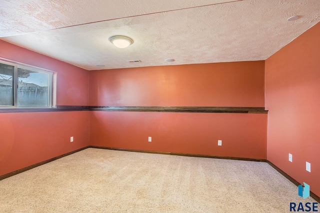 spare room with a textured ceiling