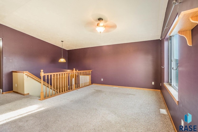 carpeted spare room with vaulted ceiling