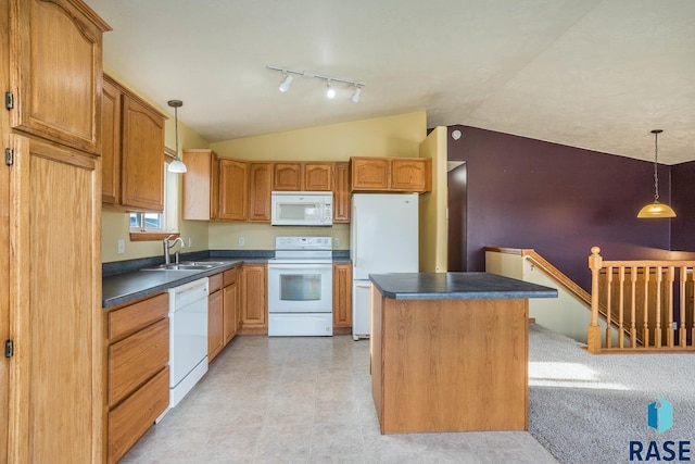 kitchen featuring sink, white appliances, decorative light fixtures, and a kitchen island