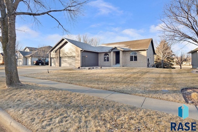 ranch-style home with a garage and a front yard