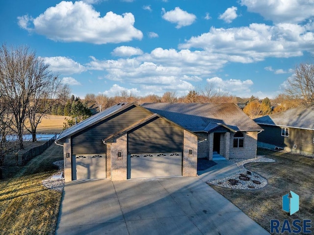 view of front of property with a garage and a front lawn