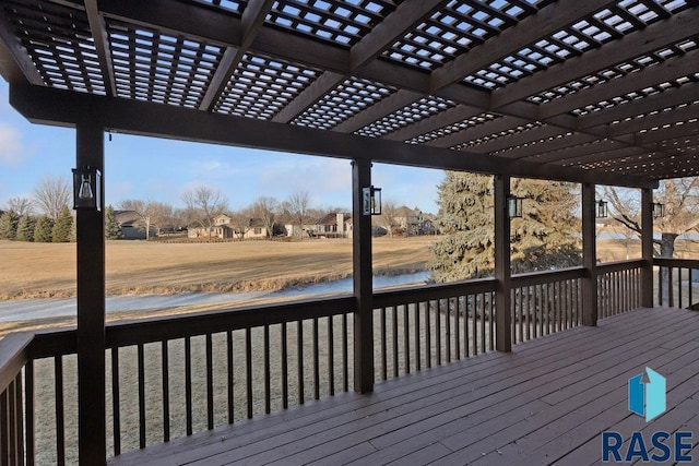 wooden deck with a water view and a pergola