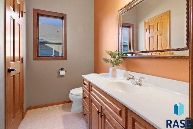 bathroom featuring tile patterned floors, plenty of natural light, toilet, and vanity