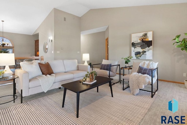 carpeted living room with high vaulted ceiling