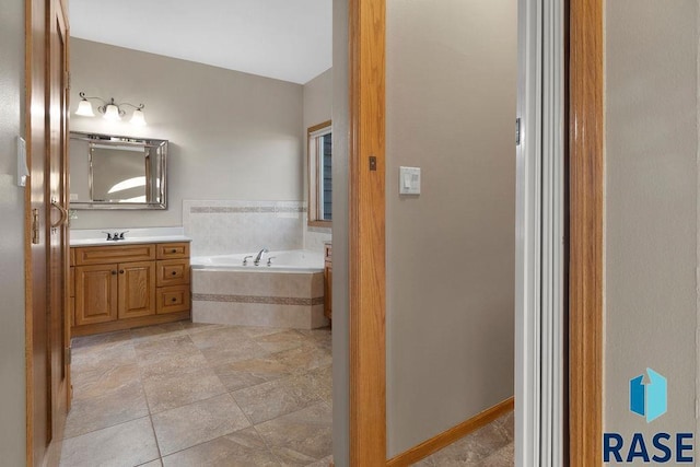 bathroom featuring a relaxing tiled tub and vanity