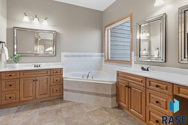 bathroom featuring vanity and a relaxing tiled tub