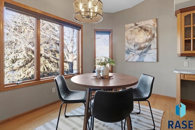 dining space featuring a chandelier and light wood-type flooring