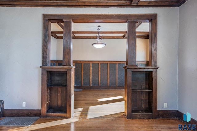 interior space with wood-type flooring and beam ceiling