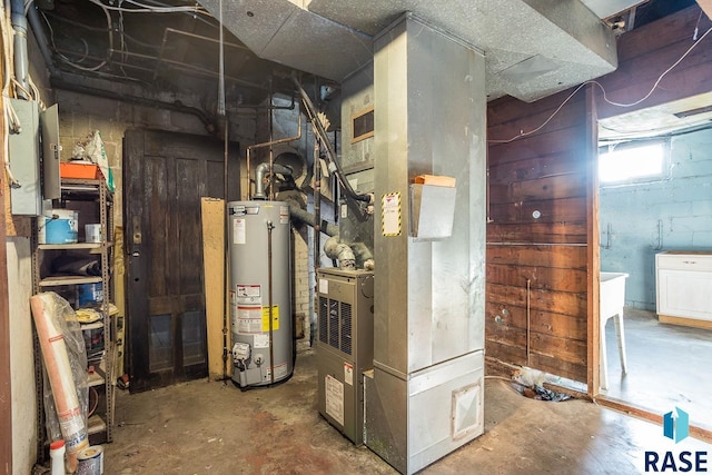 utility room with heating unit and water heater