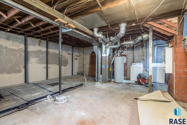 basement featuring heating unit, washer and clothes dryer, and water heater