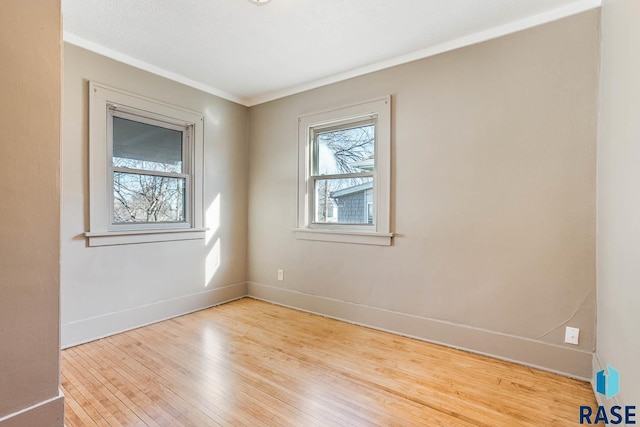 unfurnished room featuring crown molding and light hardwood / wood-style flooring