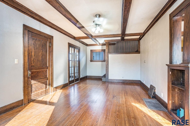 unfurnished room featuring hardwood / wood-style flooring, coffered ceiling, crown molding, beam ceiling, and french doors