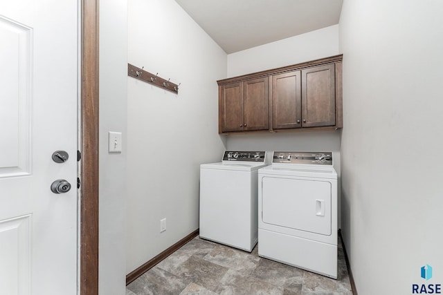 washroom featuring cabinets and independent washer and dryer