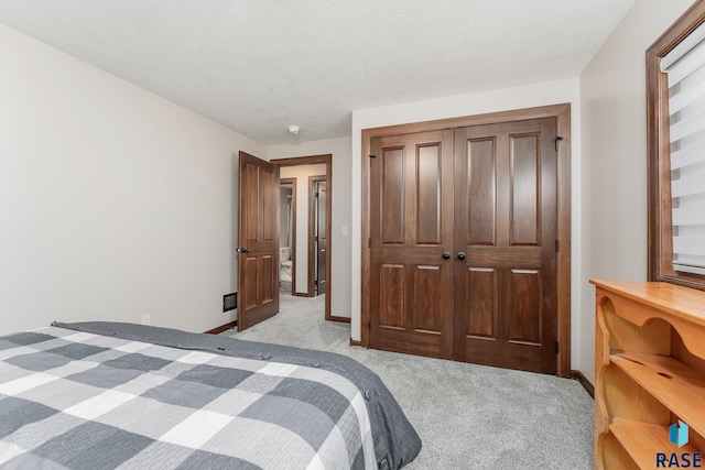 carpeted bedroom featuring a closet