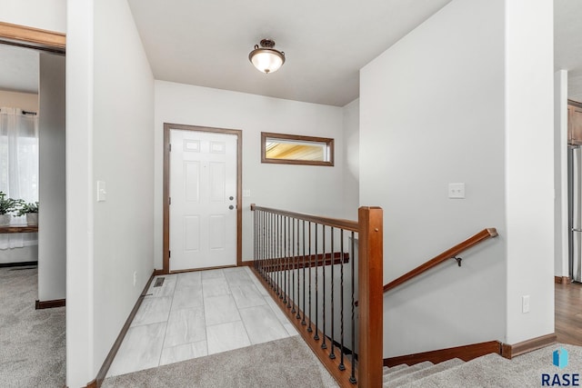 foyer featuring light carpet