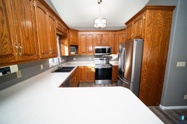 kitchen with pendant lighting, sink, dark hardwood / wood-style floors, and appliances with stainless steel finishes